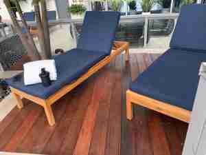A royal blue lounge chair sitting on top of an ipe wood deck in Wellington.