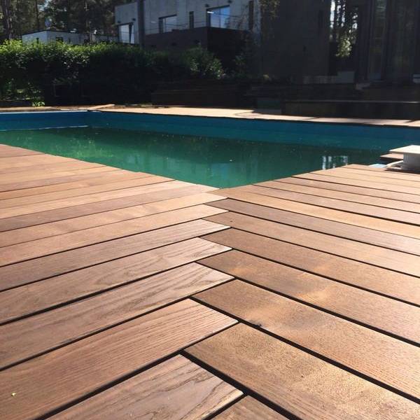 Pool deck with thermally modified wood