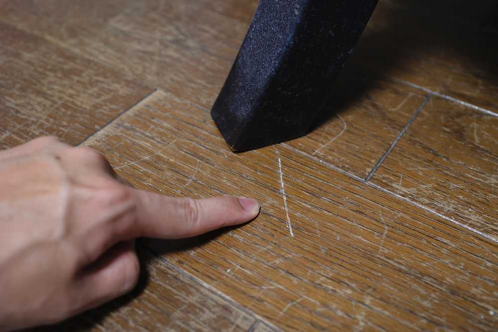 Scratched and damaged hardwood floor plank